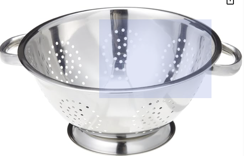 Stainless steel colander draining pasta in a bright kitchen